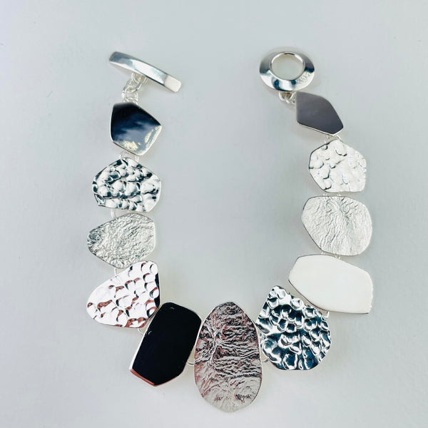 Multi Textured Silver Linked Bracelet.