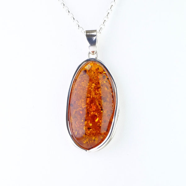 Long Oval Amber and Silver Pendant.