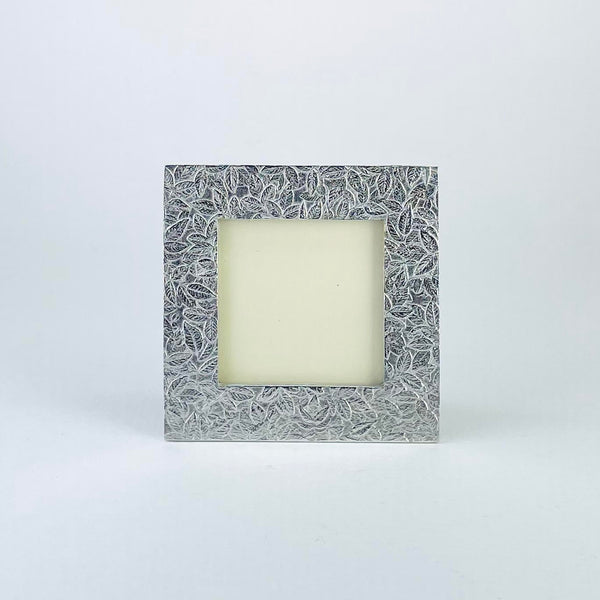 Square pewter frame with a leaf design. The leaves are small and scattered across the whole frame covering all the space in a random fashion., 