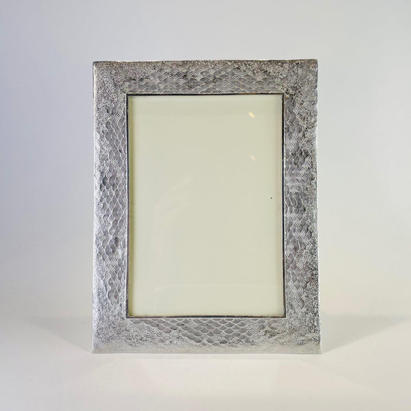 rectangular grey pewter photo frame with a small wave design etched all around the frame.