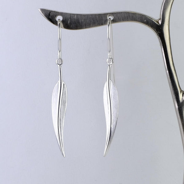 Simple matt silver leaf shaped earrings. Long and slim  with a central vein.