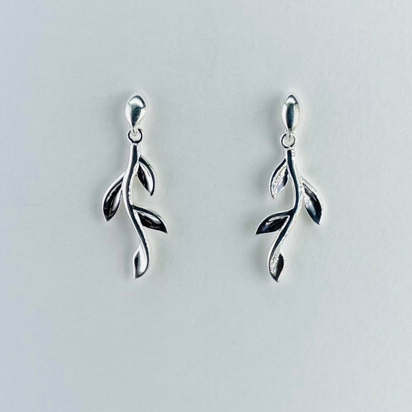 Each earring looks like a silver twig with four leaves on each. The leaves , two on each side, are evenly spaced along the twig like a growing plant.