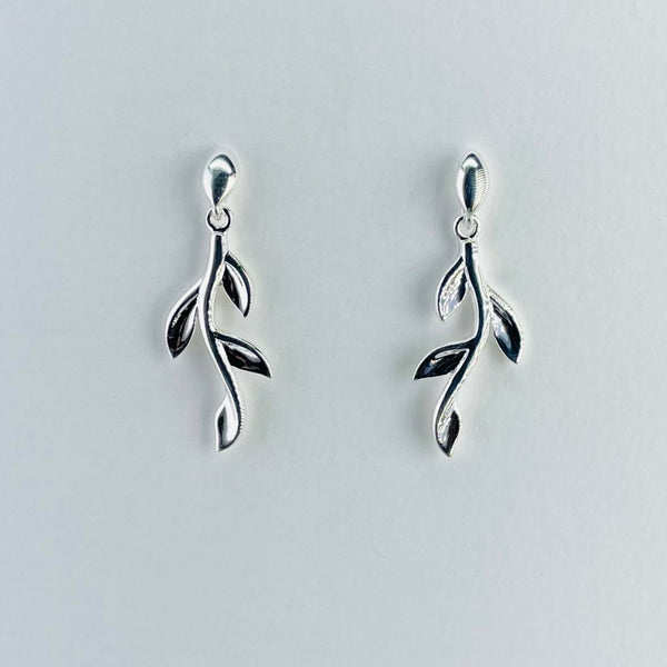 Each earring looks like a silver twig with four leaves on each. The leaves , two on each side, are evenly spaced along the twig like a growing plant.