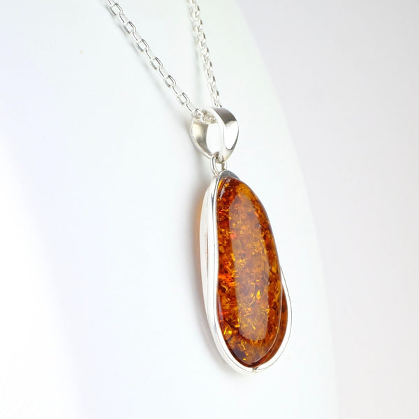 Long Oval Amber and Silver Pendant.