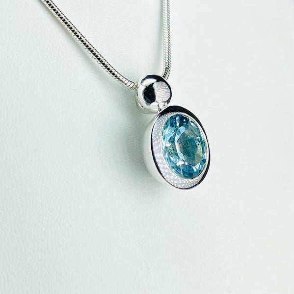Round Blue Topaz and Sterling Silver Pendant.