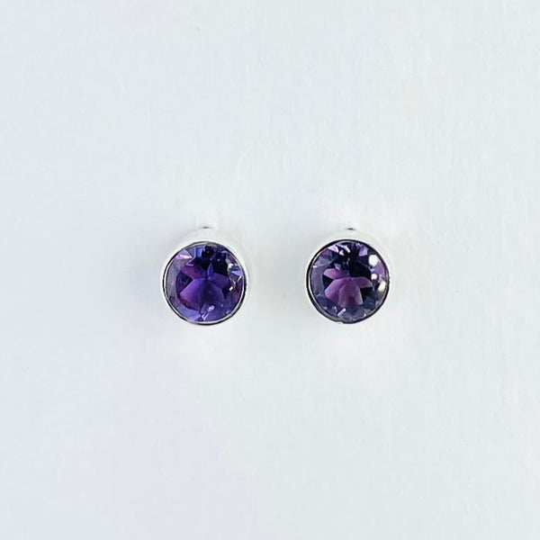 Round amethyst faceted stones are very simply surrounded by silver.