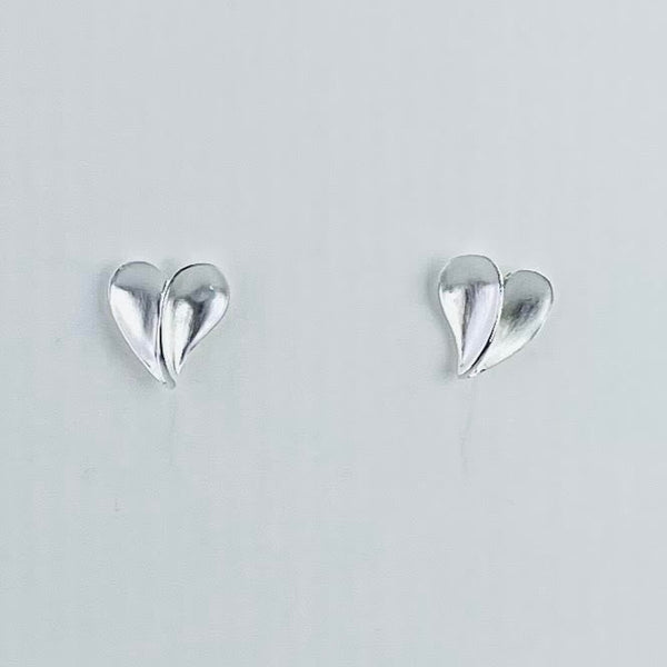 Silver hearts, a mirror image of each other. There is a central 'vein' and the two halves are slightly scooped out.