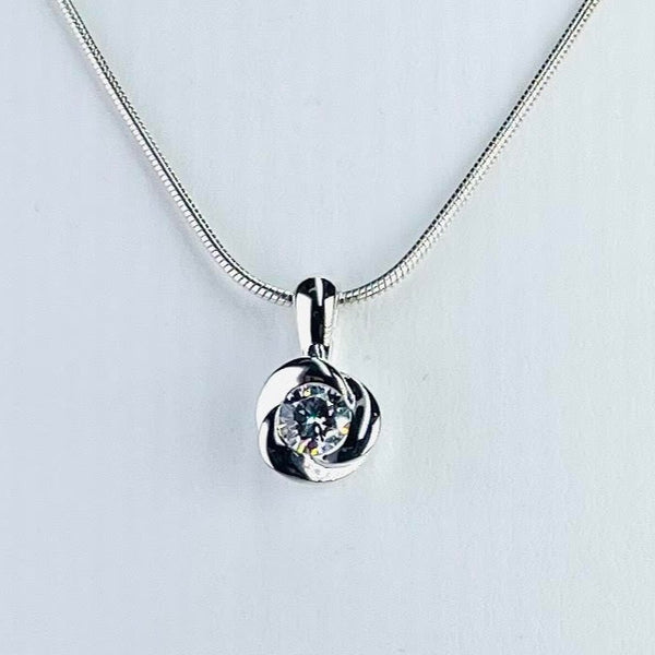 Small round sparkly Cz stone is set in a chunky shiny silver surround of gently twisted silver  - three little twists. It hangs on a solid silver bail with a snake chain.