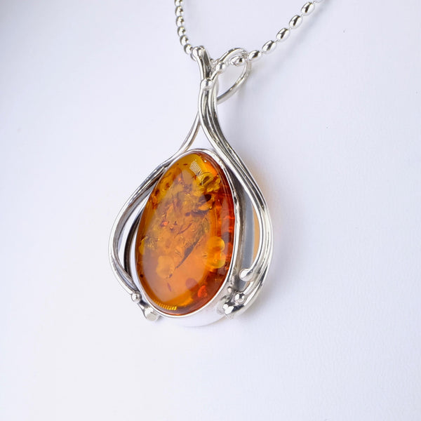 Decorated Amber and Silver Pendant.