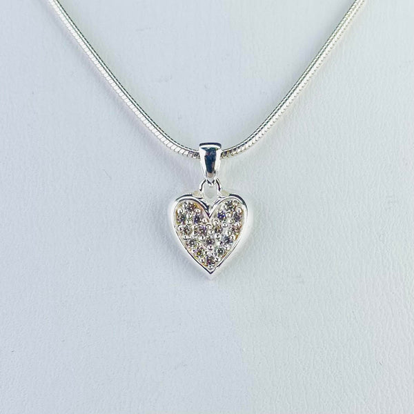 Silver heart outline within which is set sixteen sparkly cubic zirconia stones. The top of the heart has a little loop connected to a solid bail with a snake chain.