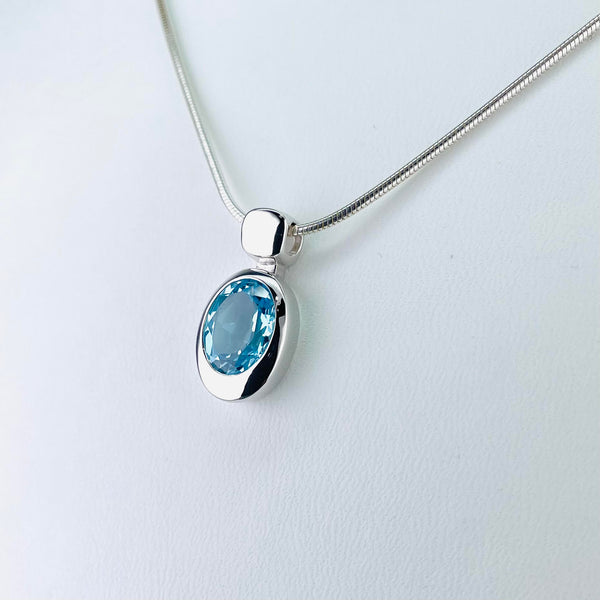Oval Blue Topaz and Silver Pendant by JB Designs.