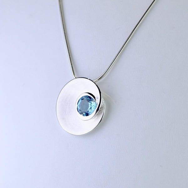 Blue Topaz and Satin Silver Pendant by JB Designs.
