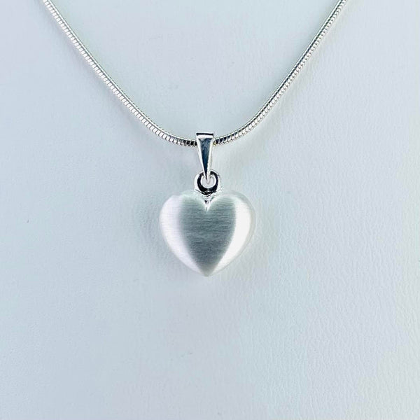 simple satin finish heart pendant attached to a shiny silver bail on a snake chain.