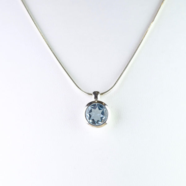 Small Round Blue Topaz and Silver Pendant.