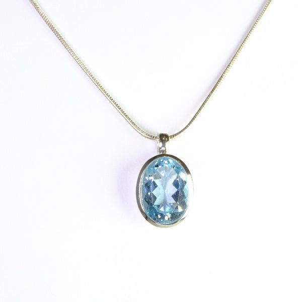 Simple Oval Blue Topaz and Silver Pendant.